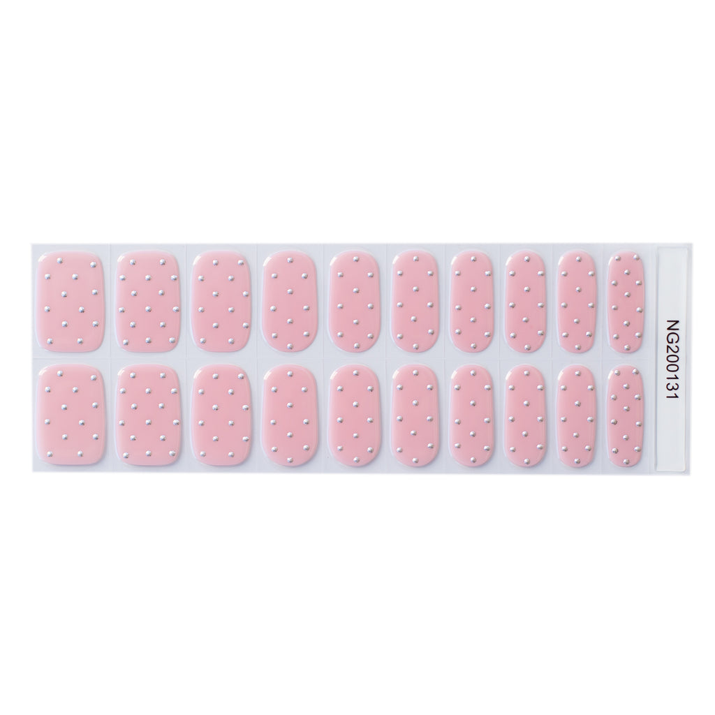 A detailed image of Nails Mailed's "Dazzled Confetti" Gel Nail Wraps, featuring a delicate light pink base punctuated by festive silver glitter polka dots. The wraps offer a blend of fun and protective care, making your nails the life of the party without compromising their health.
