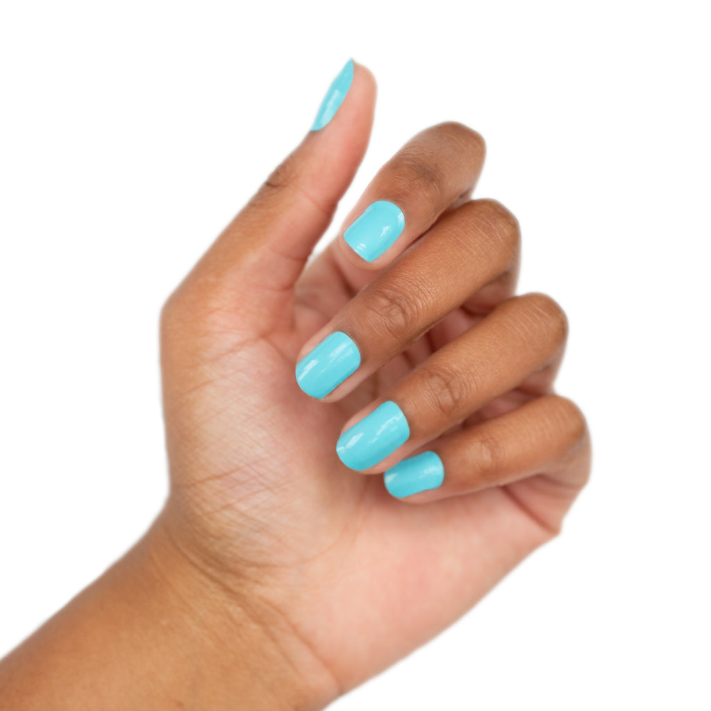 This photo showcases our aqua nail wraps on a model. The overall aesthetic is clean and polished against a white background.