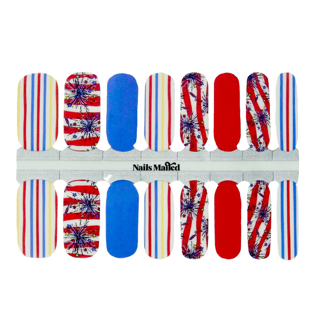 A set of patriotic nail wraps featuring a colorful base with bold stripes and fireworks designs. The wraps are arranged neatly on a plain white background, highlighting their vibrant colors of red, white, blue, and yellow. 