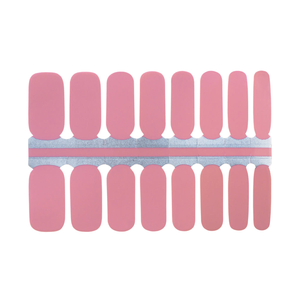A photo of Bubblegum nail wraps against a white background. The nail wraps feature a soft, muted pink color and a glossy finish. The wraps are rectangular in shape and are lined up next to each other in the photo. The edges of the wraps are slightly curved to fit the shape of a fingernail. The photo is well-lit, and the white background provides a clean and simple backdrop for the product.