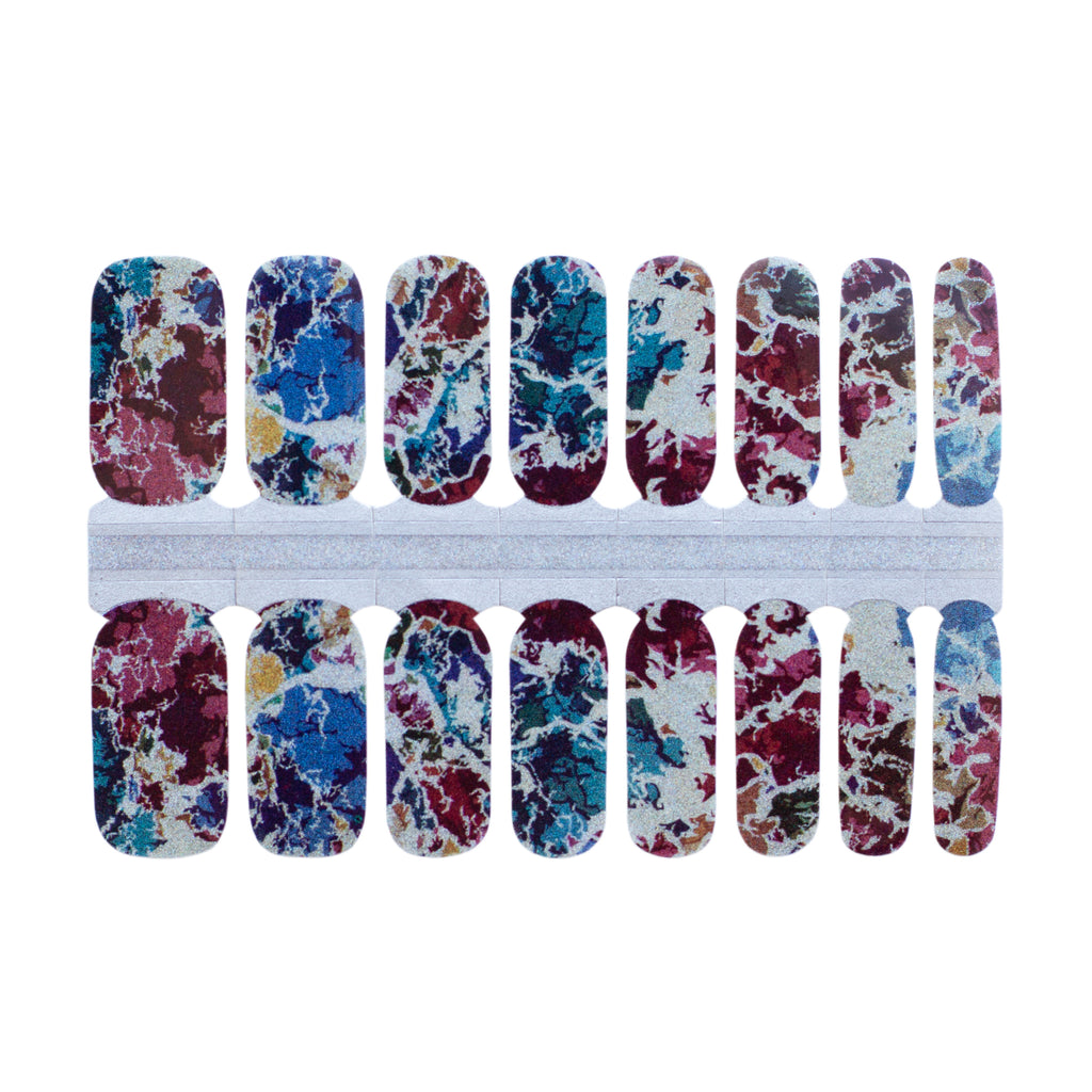 Close-up image of Wicked Classic Nail Wraps, showcasing a white background fragmented by deep fall colors and accented with sparkling glitter elements.