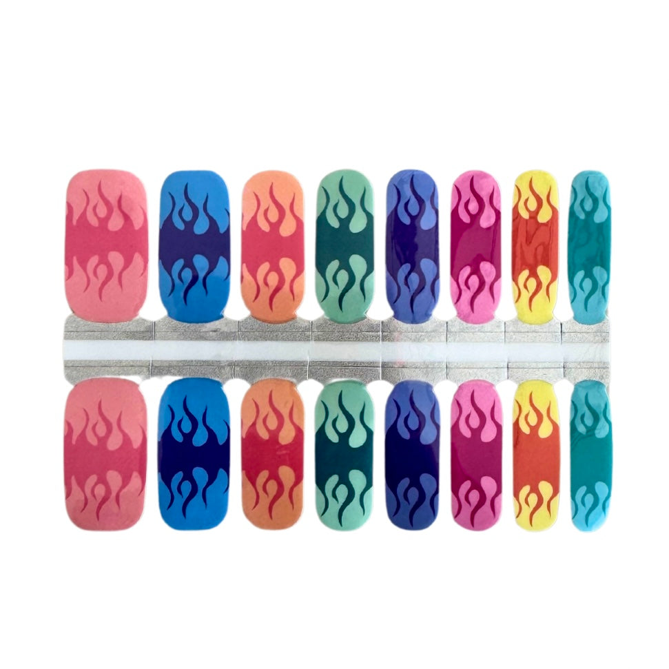 A close-up photo of vibrant nail wraps featuring rainbow colors and flame designs on each nail, subtly incorporating a pride aspect into the design