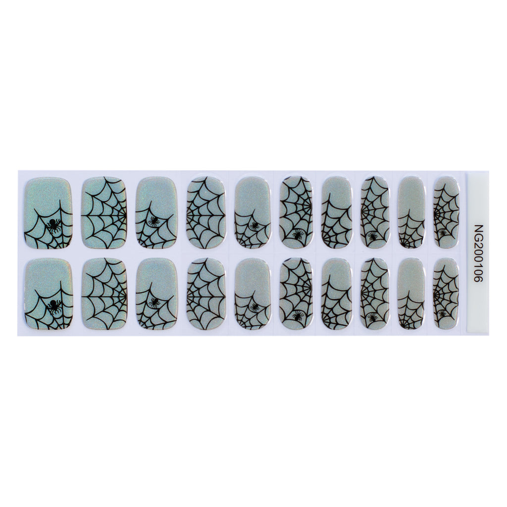 Arachnid Elegance gel nail strips showcased against a white background, featuring a silver-blue iridescent base with intricate black spiderweb designs.