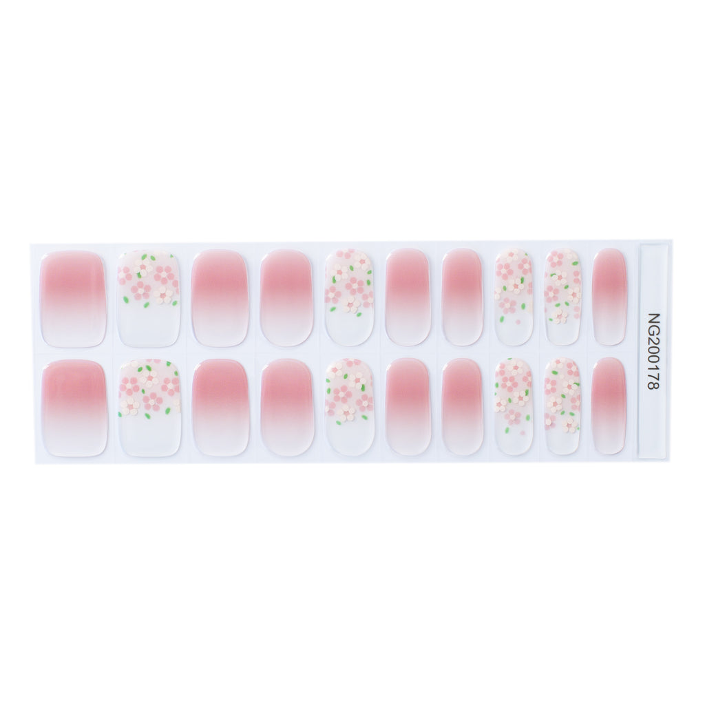 Image of Blooming Ombre gel nail wraps, showcasing a beautiful pink to white ombre base with accent nails adorned with dainty pink flowers. The perfect accessory for a feminine and elegant nail look. - NailsMailed