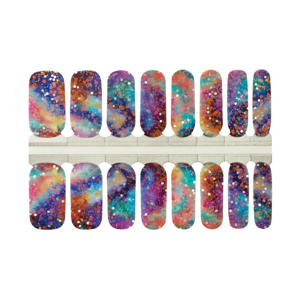 A photo of Colorful Sky nail wraps on a white background. The nail wraps feature a bold and playful mix of bright colors with big, bold glitter accents. The wraps are rectangular in shape and are lined up next to each other in the photo. The edges of the wraps are slightly curved to fit the shape of a fingernail. The photo is well-lit, and the white background provides a clean and simple backdrop for the product.
