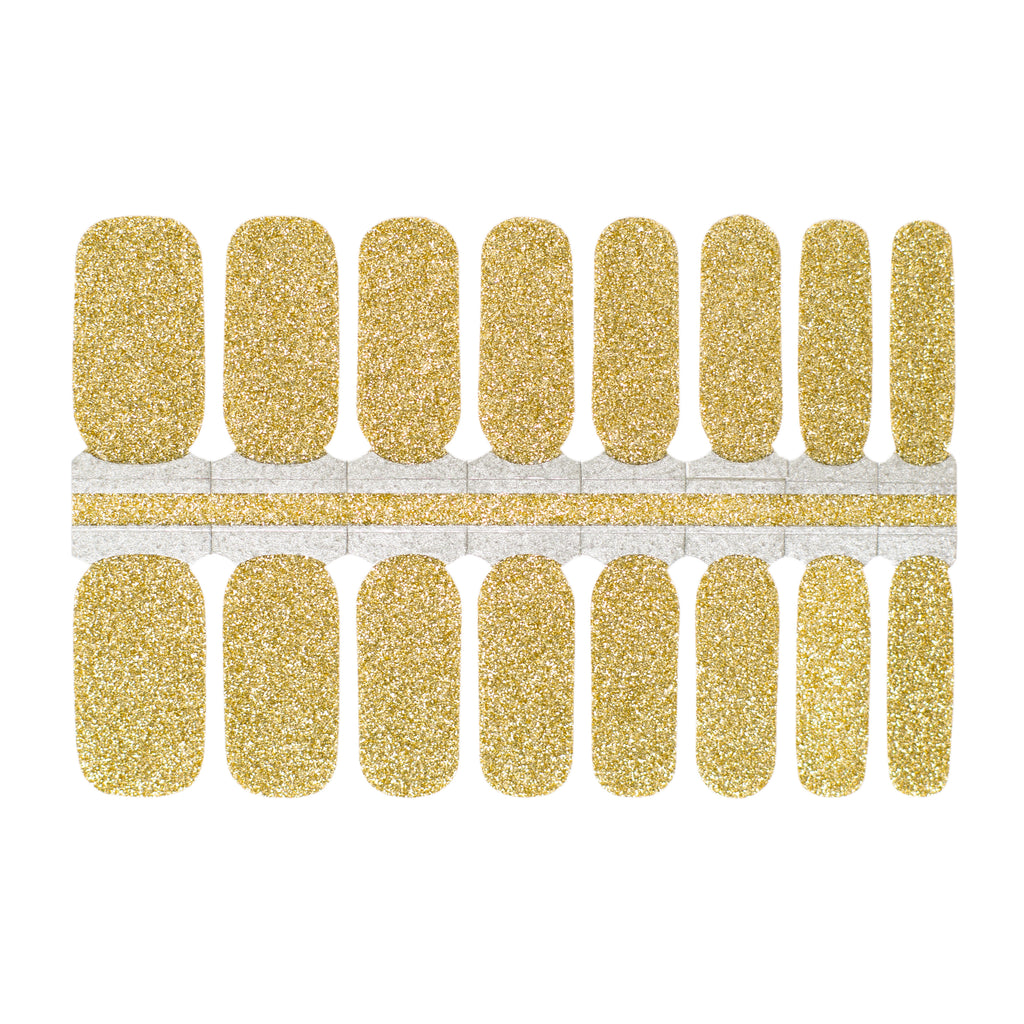 A close up of gold nail wraps with glitter on a white background. These champagne glitter nail wraps feature a shimmering and glamorous shade of gold and are made of high-quality materials. The wraps are easy to apply and remove, making them a convenient and stylish choice for any manicure.
