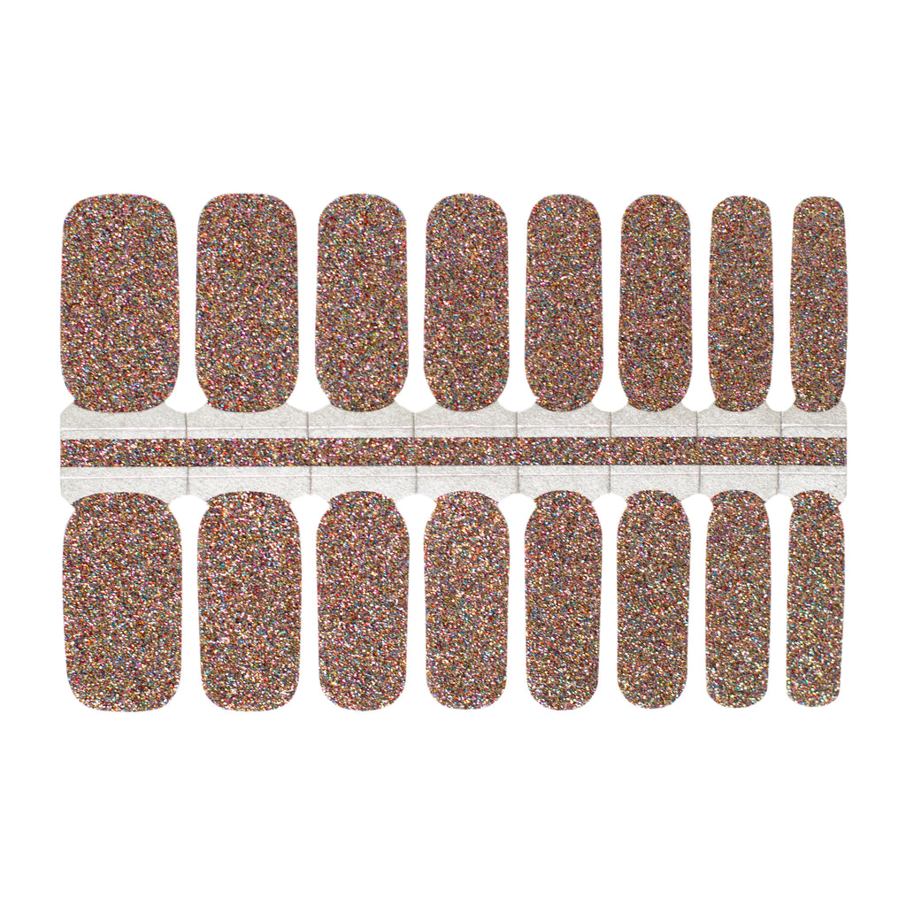 A photo of nail wraps with a brown base and multicolored glitter accents on top. The wraps are rectangular in shape and are lined up next to each other in the photo. The edges of the wraps are slightly curved to fit the shape of a fingernail. The glitter accents are a mix of various colors, including pink, blue, yellow, and green, giving the wraps a playful and festive look. The photo is well-lit, and the white background provides a clean and simple backdrop for the product.