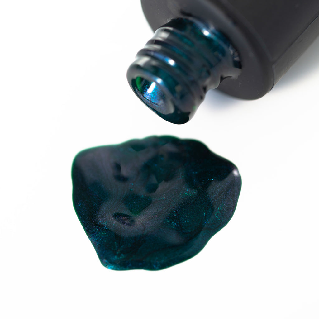 Close-up of a bottle of deep green Shellac Gel Polish with a shimmery finish on a white background. The bottle has a black cap and the polish appears smooth and glossy.