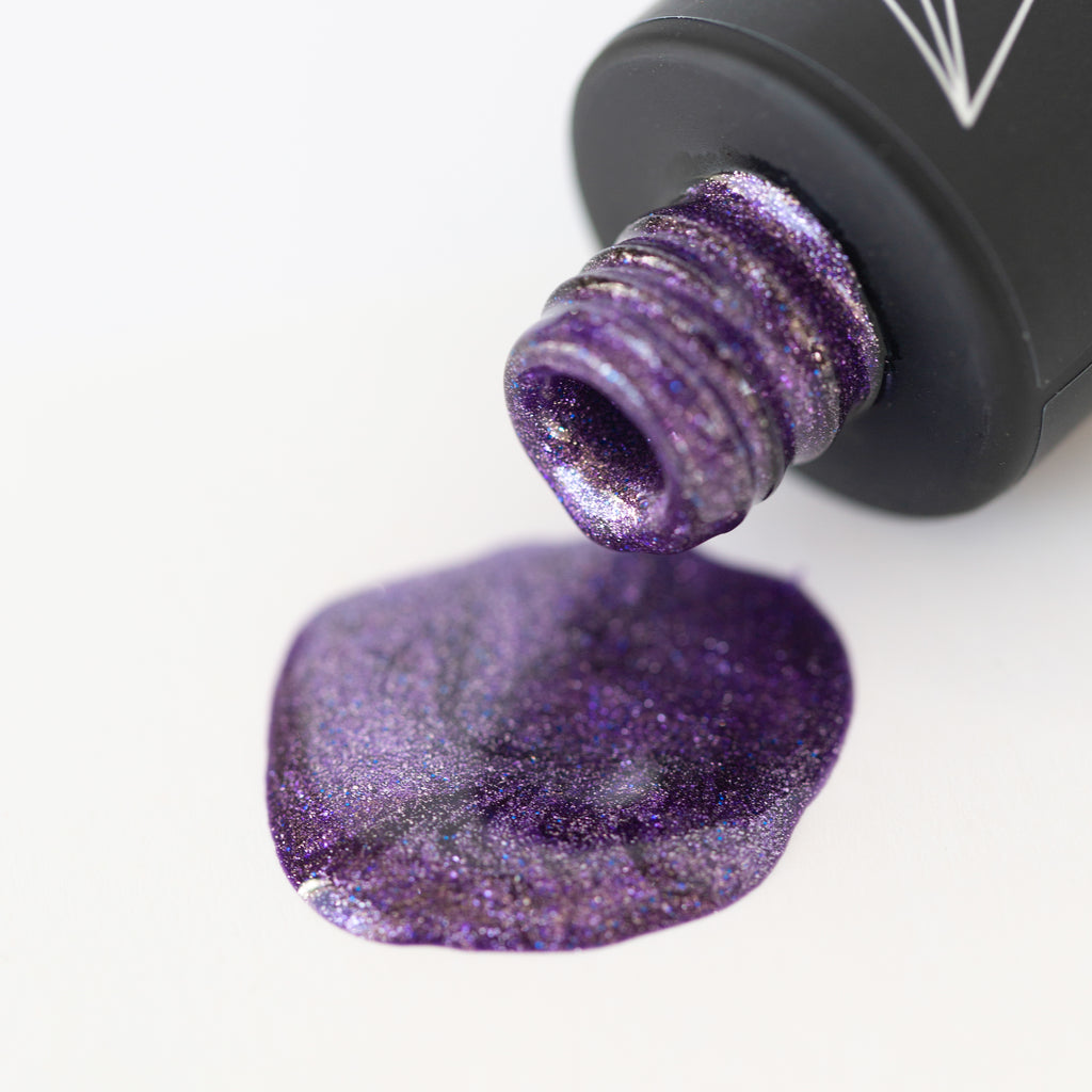 A bottle of Shimmering Twilight Shellac Gel Polish, a lavender purple shade with a shimmer finish and glitter, on a white background. The bottle has a black cap and the polish appears smooth and glossy. A brush is attached to the cap.