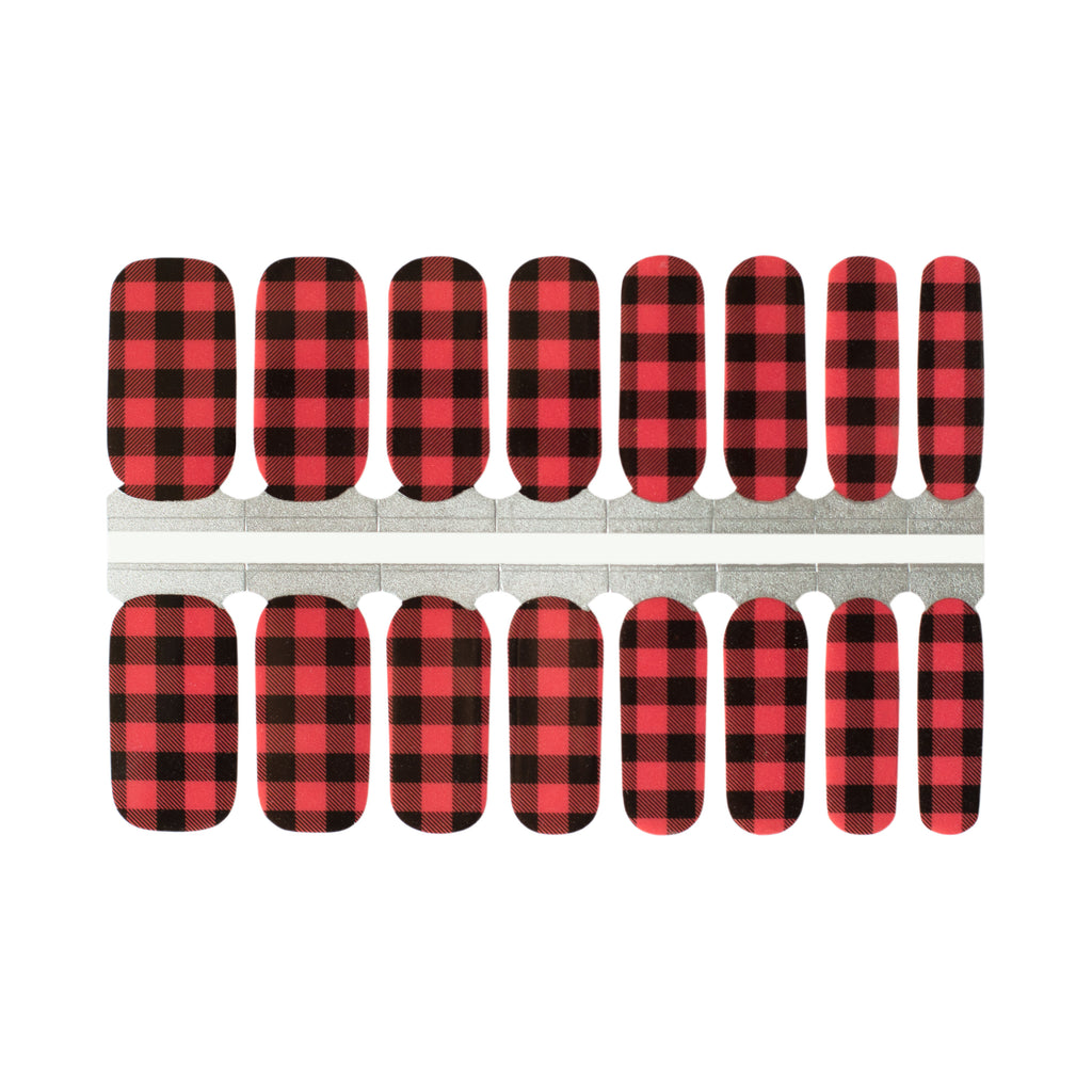 A close-up of Buffalo Plaid nail wraps on a white background. The wraps feature a classic black and red plaid pattern that adds some stylish flair to any outfit. The wraps are made of high-quality materials and are easy to apply and remove, making them a convenient choice for any manicure.