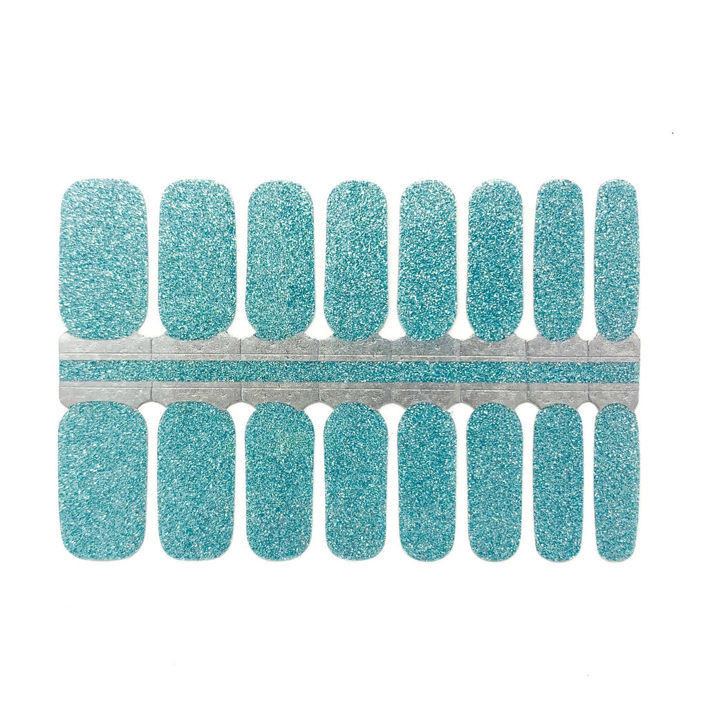 Close-up of Sparkling Aqua nail wraps from Nails Mailed, showing an aqua base with full coverage of glitter, set against a white background.