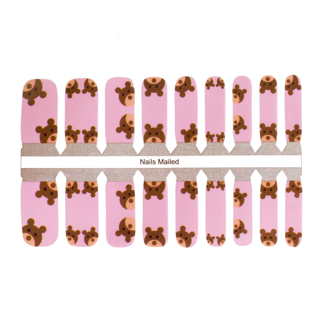 Teddy bear nail wraps on a white background. The wraps feature adorable teddy bear designs and are made of high-quality materials. The wraps are easy to apply and remove making them perfect for a kids manicure