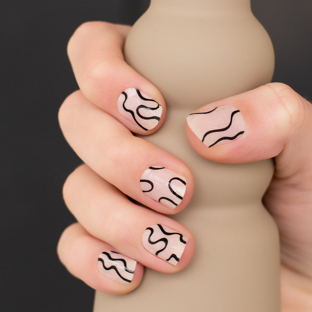 these squiggle nails are beige and black nail wraps
