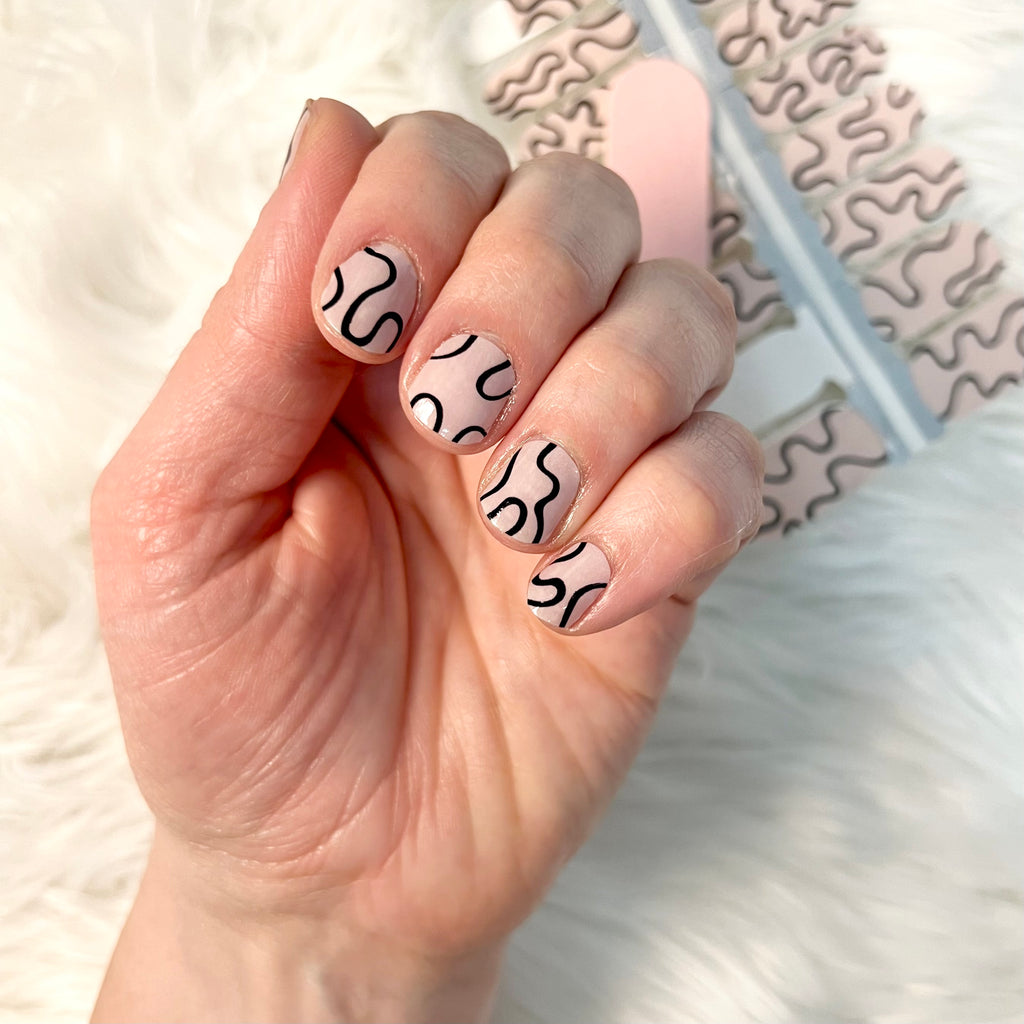 these squiggle nails are beige and black nail wraps