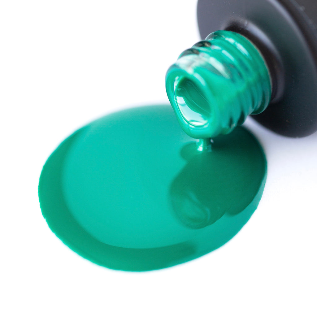 A bottle of Emerald Shellac Gel Polish, a rich and lustrous emerald green shade with a shiny finish, on a white background. The bottle has a black cap and the polish appears smooth and glossy. A brush is attached to the cap.