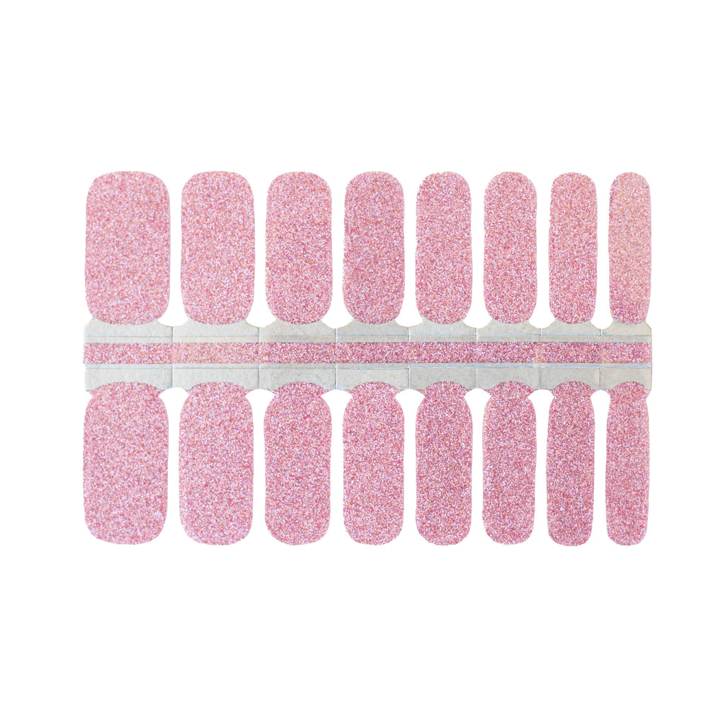 A close-up of pink glitter nail wraps on a white background. The wraps feature a playful and vibrant shade of pink and are made of high-quality materials. The wraps are easy to apply and remove, making them a convenient and stylish choice for any manicure.