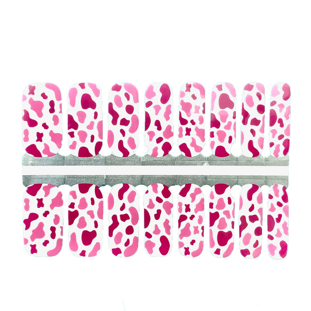 Pink cow print nail wraps on a white background