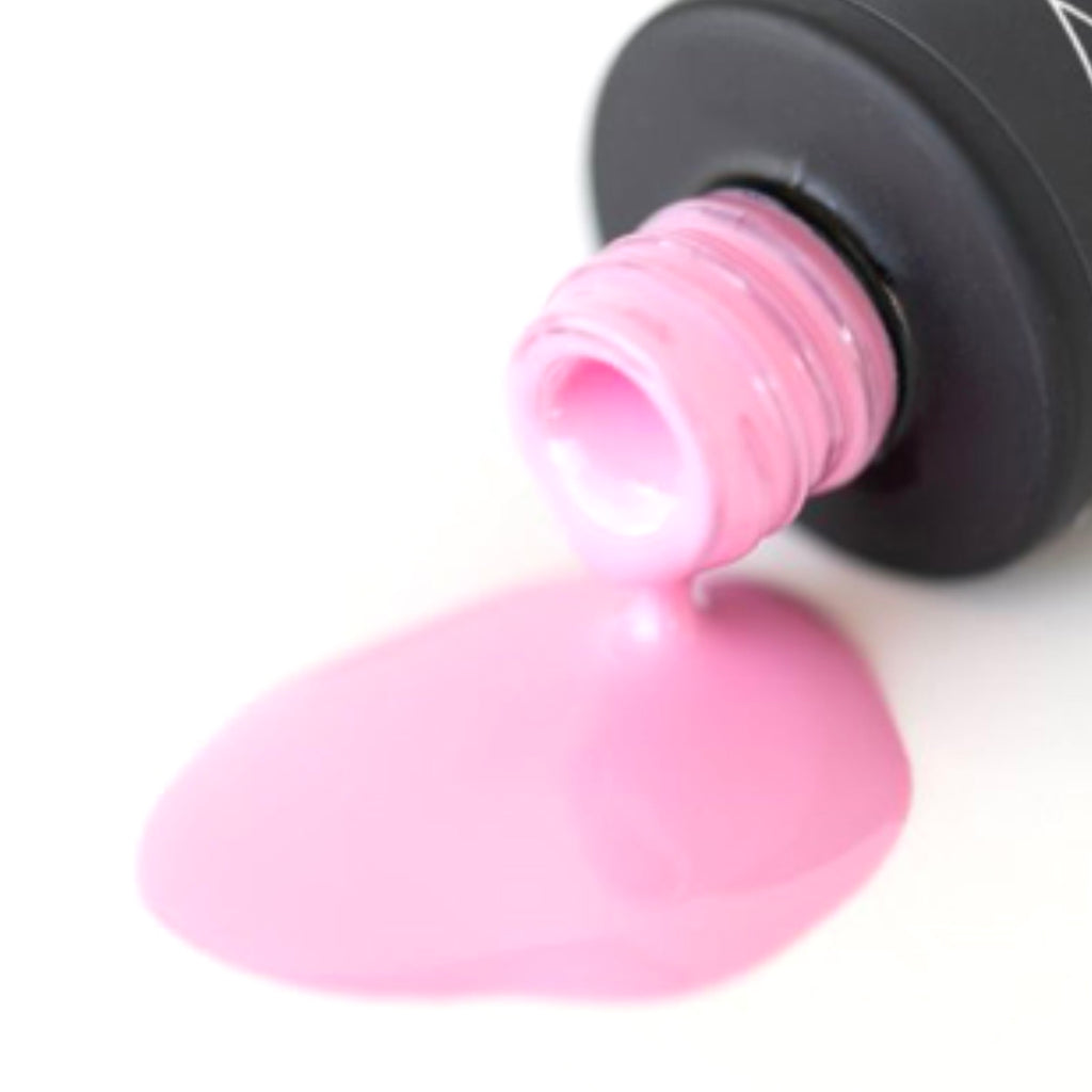 A bottle of Strawberry Bubblegum shellac gel nail polish, displaying its charming baby pink hue, set against a pristine white background.