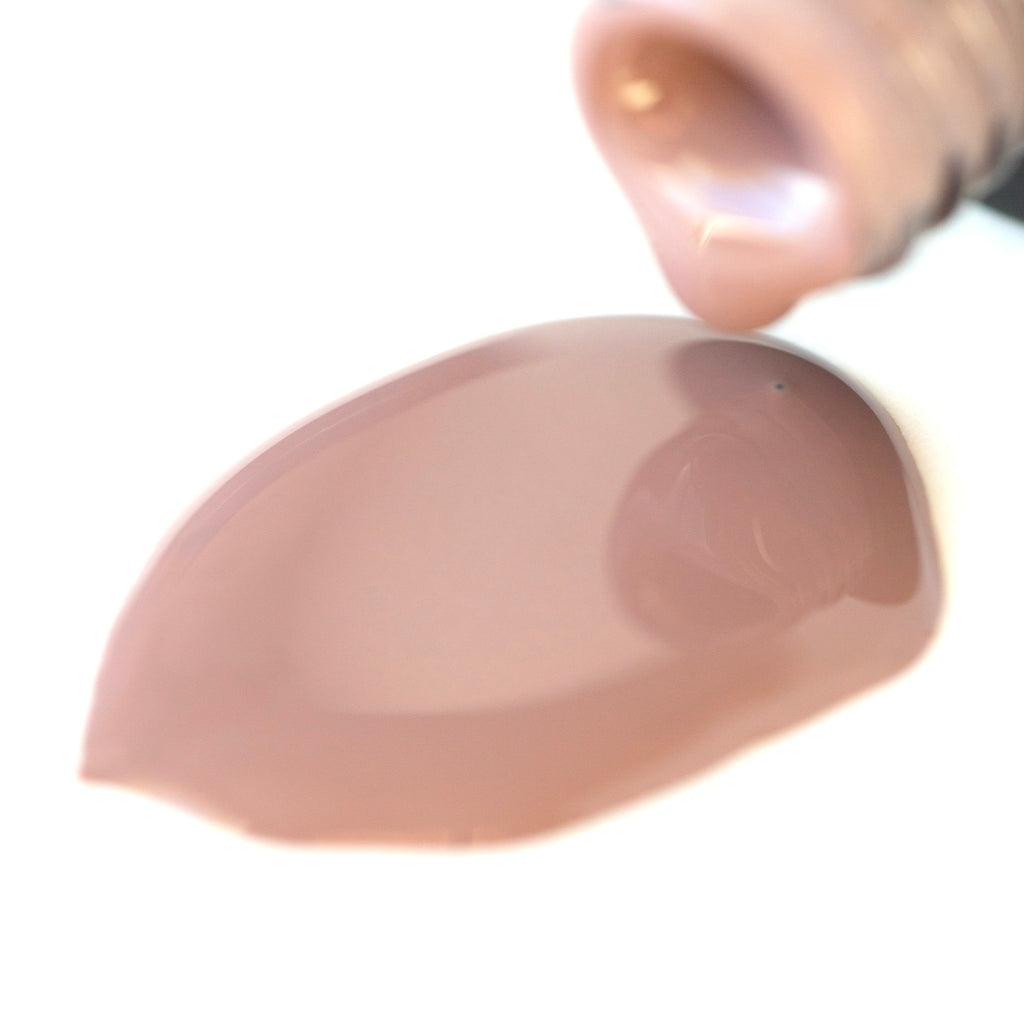 A bottle of Suave Mauve shellac gel nail polish, featuring its rich tan color with subtle pinkish hues, elegantly showcased against a crisp white background.
