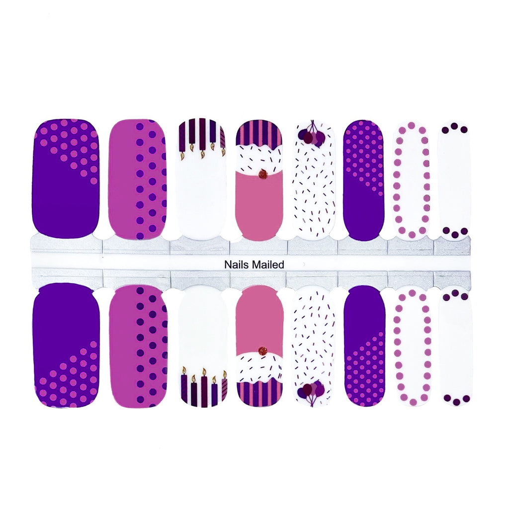 A set of purple and pink nail wraps with birthday cupcakes and balloons printed on them, perfect for adding a festive touch to your nails.