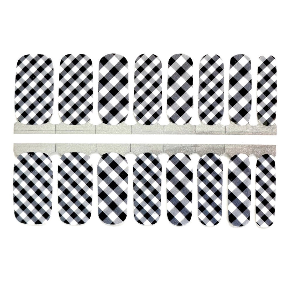 A close-up image of Black Gingham nail wraps, displaying a white base with black gingham patterns, perfectly encapsulating fall nails style. Ideal for nail stickers and nail wrap enthusiasts looking for seasonal flair. - NailsMailed
