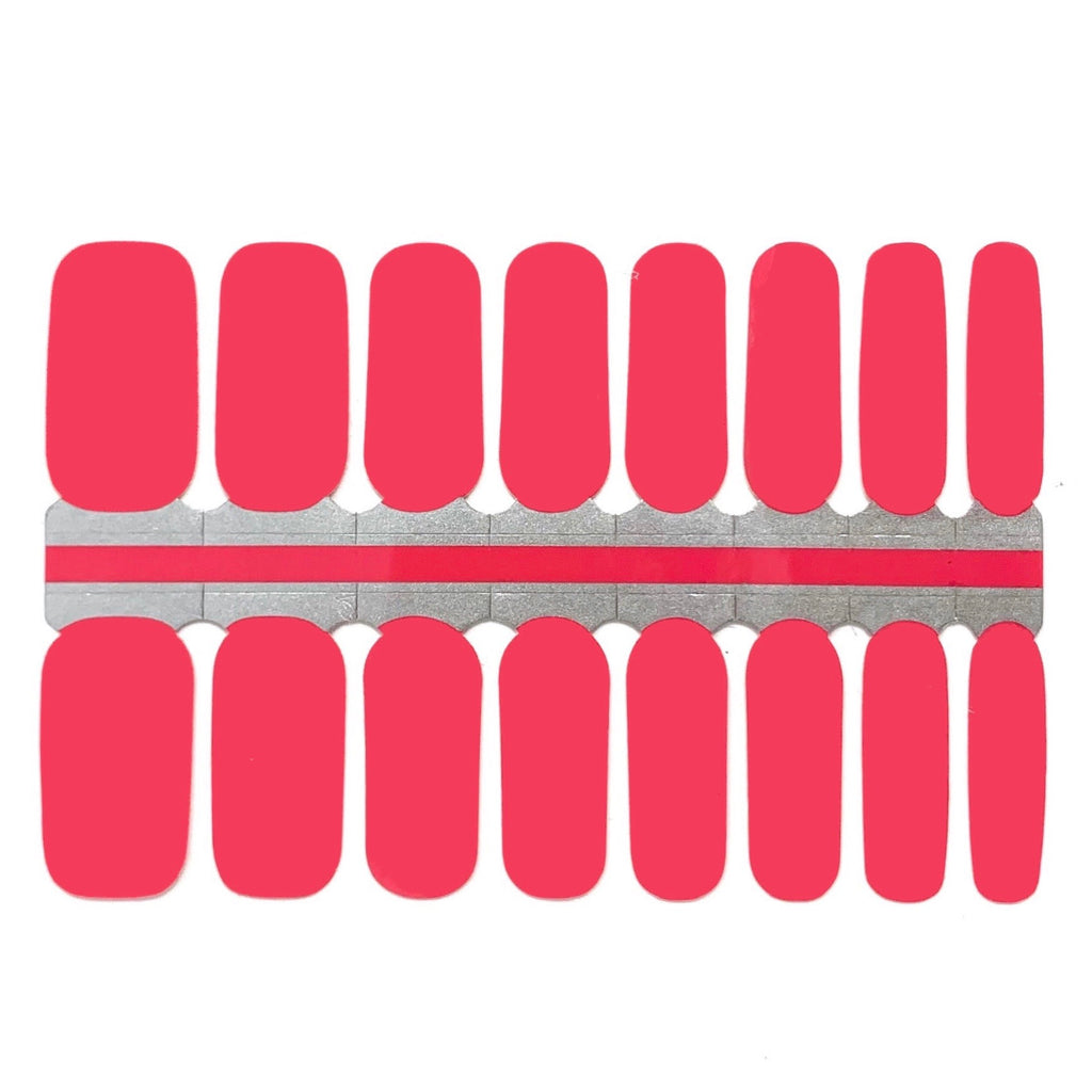 A photo of Coral nail wraps featuring a coral pink color with a glossy finish. The wraps are rectangular in shape and are lined up next to each other in the photo. The edges of the wraps are slightly curved to fit the shape of a fingernail. The photo is well-lit, and the white background provides a clean and simple backdrop for the product. The wraps have a simple and elegant design and are perfect for adding a pop of color to any outfit.